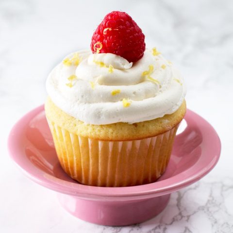 Lemon Raspberry-Filled Cupcakes with White Chocolate Buttercream Frosting | cakenknife.com